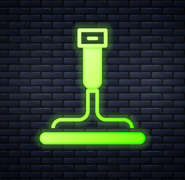 Glowing neon Cleaning service with of rubber cleaner for windows icon isolated on brick wall background. Squeegee, scraper, wiper. Vector