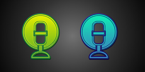 Green and blue Microphone icon isolated on black background. On air radio mic microphone. Speaker sign. Vector