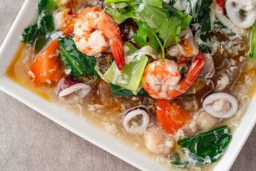 kwetiau siram is Chinese cuisine which is popular in Indonesia, cooked by frying added with complementary vegetables and chicken, seafood or beef meat and thick soup.