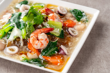 kwetiau siram is Chinese cuisine which is popular in Indonesia, cooked by frying added with complementary vegetables and chicken, seafood or beef meat and thick soup.