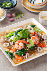 kwetiau siram is Chinese cuisine which is popular in Indonesia, cooked by frying added with complementary vegetables and chicken, seafood or beef meat and thick soup.