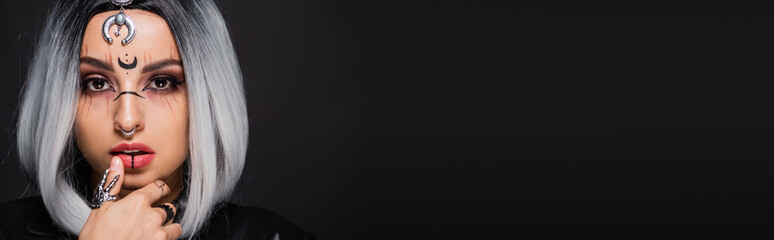 portrait of ash blonde woman with witch style makeup and ash blond hair isolated on black, banner.
