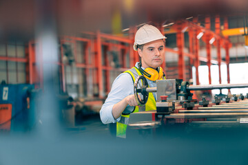 Obraz premium Smart professional Caucasian quality control,Industrial,factory engineer,technician,worker man in safety helmet operate machine in steel metal sheet production,manufacture worker concept in copy space