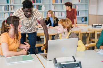 Students from different cultures sharing knowledge in the university library