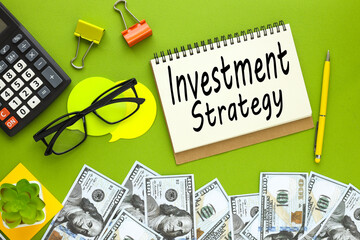 business and technology concept. banknotes of money lie on a green surface. text on notepad. Investment strategy