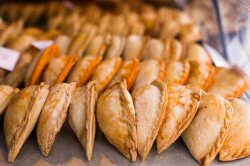 freshly baked empanadas with different fillings for sale