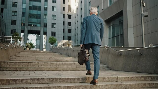 Restaurant chain owner walks on stairs to office building