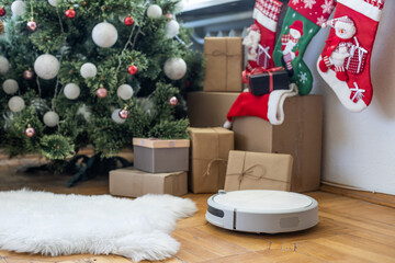 Robotic vacuum cleaner hoovering the floor at christmas