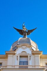 Nice building in Murcia with the Phoenix bird on the dome on a sunny day