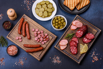 Delicious fresh smoked sausages cut with slices on a wooden cutting board