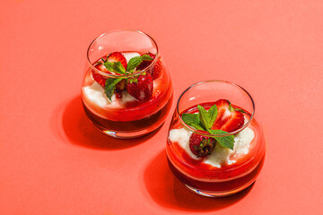 Italian dessert panna cotta in glass with strawberries. Healthy sweet food, hard light, dark shadow