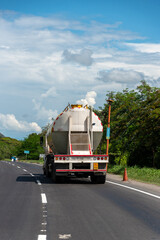 Fuel tank truck on a Colombian highway on a sunny day.