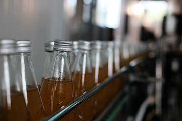 Drink factory production line fruit juice beverage product at conveyor belt.