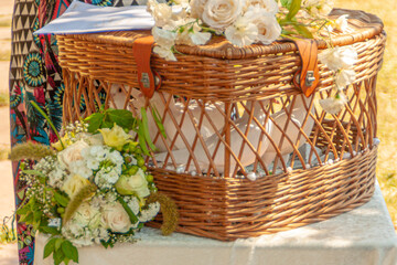 woven basket with white doves waiting for their flight at a wedding celebration