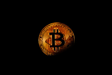 Bitcoin in the shadows black background
