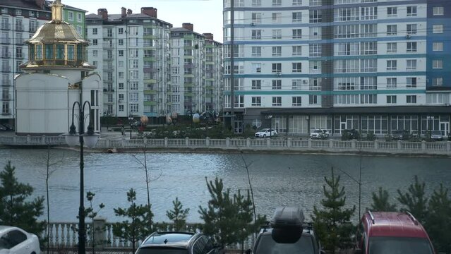 Lake Among Houses in Residential Area. Cars Paked on Parking Lot near Apartment Buildings Block of Flats. Overcast Day. Ukraine Ivano-Frankivsk. 2x Slow motion 60 fps 4K