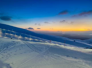 Fotobehang Ski resort at sunset. Nothern winter landscape. ski corduroy. © aksol