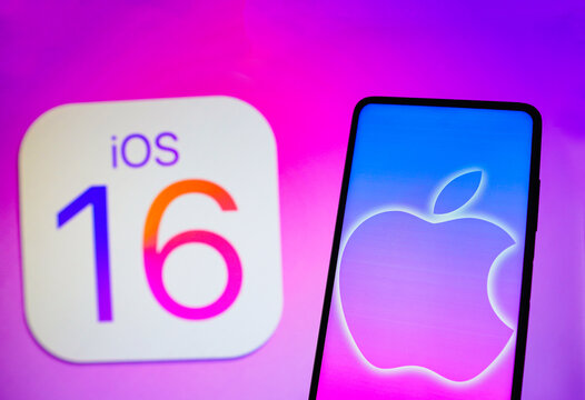 September 13, 2022, Brazil. In this photo illustration the Apple logo seen displayed on a smartphone and in the background, the iOS 16 operating system logo.