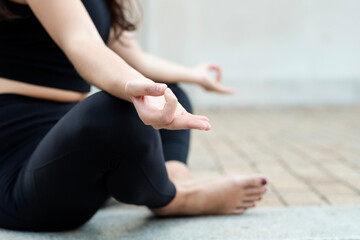 Close-up of legs and arms of caucasian woman doing yoga on the floor.