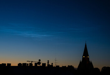 noctilucent clouds over stockholm city skyline