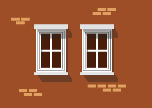 Zwei Fenster in einem Backsteinhaus. 