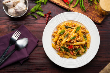 Stir-Fried Minced pork and Basil with Penne rigate pasta,Pad Kra Pao,Thai fusion food.Top view