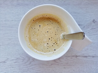 Cup of coffee with a spoon seen from above