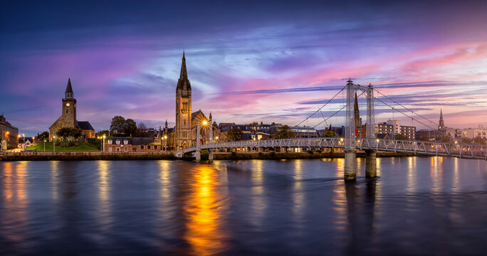 Panoramic view of the cityscape of Inverness, Scotland, during evening time with Greig Street Bridge, River Ness and the old town