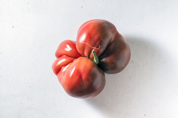 ugly tomato on a light background.