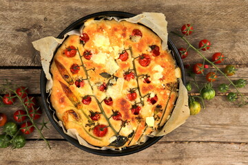 appetizing focaccia bread with cherry tomatoes and basil selective focus, homemade bread