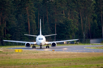 Commercial airplane on the way to the runway with front to the camera. Waiting for takeoff...