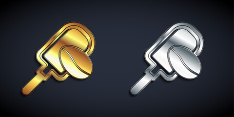 Gold and silver Spatula with coffee grain icon isolated on black background. Coffee beans. Long shadow style. Vector