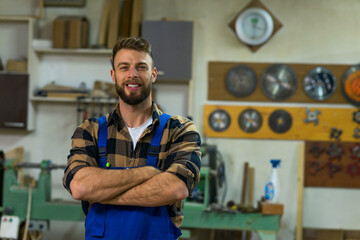 Portrait of smiley handsome carpenter at his workplace