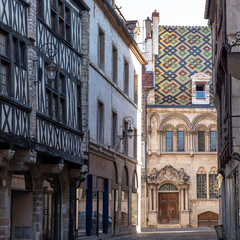Fototapeta na wymiar Beautiful architecture in the city centre of Dijon in France with typical coloured tile roofs