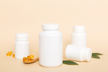 Omega-3 capsules lie in white bottle on a table with green leaves background. Fish oil tablets. Biologically active additives. omega 6, omega 9, vitamin A, E, D, vitamin D3 top view with copy space