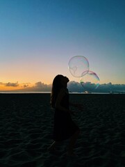 playing with bubbles on beach in Hawaii