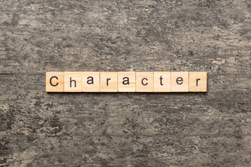 CHARACTER word written on wood block. CHARACTER text on cement table for your desing, concept