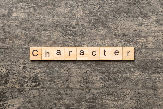 CHARACTER word written on wood block. CHARACTER text on cement table for your desing, concept