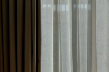 Light and shadow concept, Classic see through white sheer curtains hanging by the window in the room with sunlight and blurred outside view, Fabric and linen background. - obrazy, fototapety, plakaty