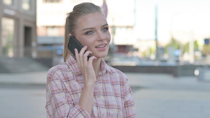 Young Woman Talking on Phone while Standing Outdoor