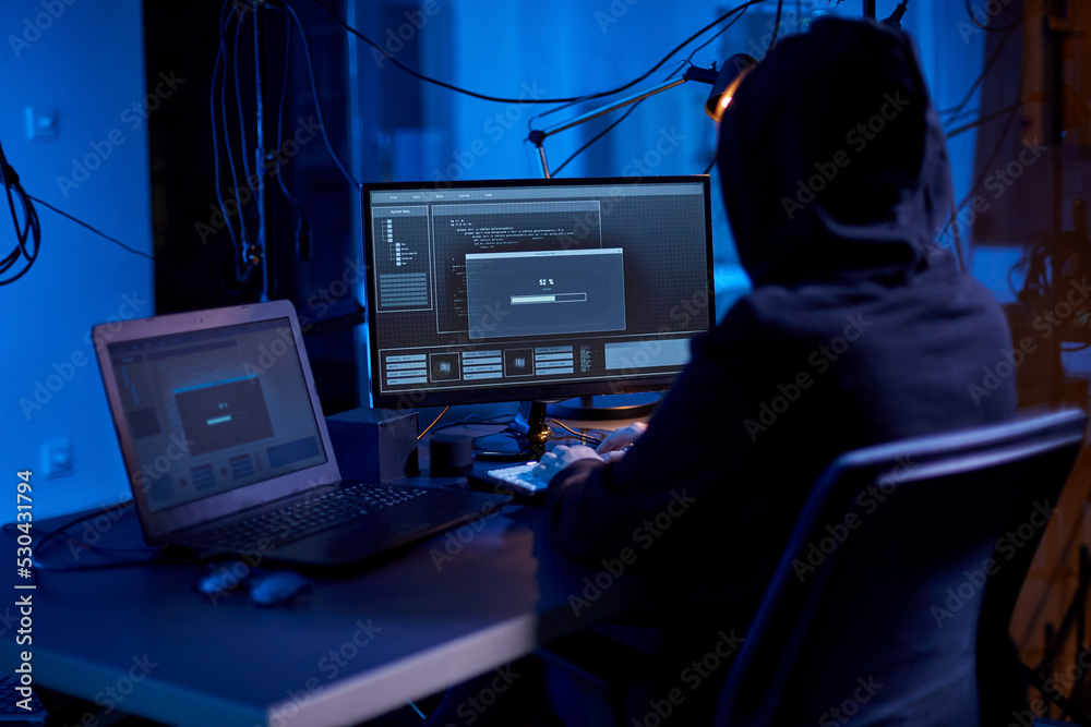 Poster cybercrime, hacking and technology concept - male hacker in dark room writing code or using computer