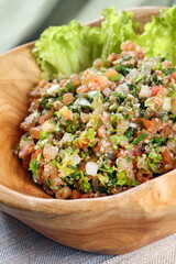 Tabbouleh, classic cold Arabic dish with tomatoes, wheat, green onions, parsley and onions