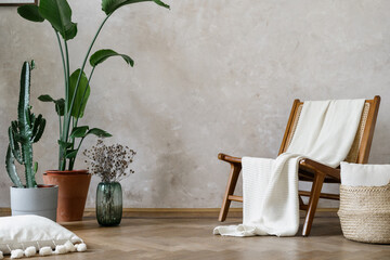 Wooden chair with white plaid, potted plant and wicker basket on the floor