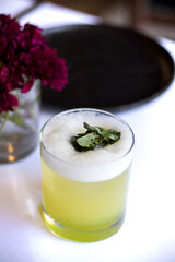 Mojito drink on table and carnation flowers with selective focus