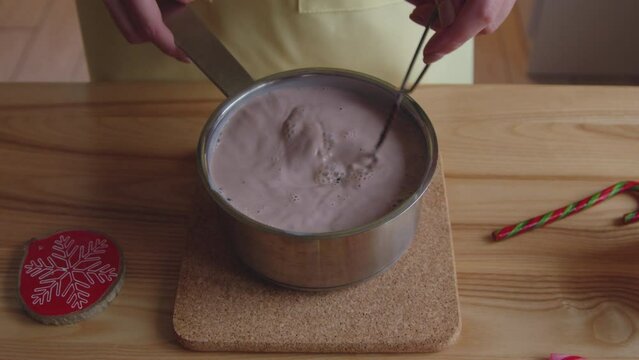 Woman Is Cooking Hot Cocoa Drink At Home, Mixing Ingredients With Milk, Sweet Warm Beverage To Taste In Winter, Close Up, Slow Motion.