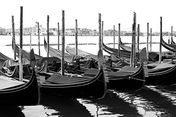 moored gondolas with the bow with the famous shape of the symbol of Venice with effect in black and...