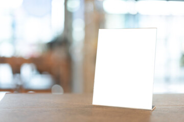 Restaurant menu frame with white blank screen on wooden table in restaurant or cafe on bokeh...