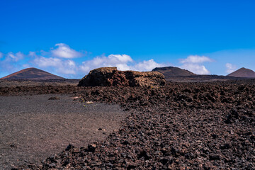 Large volcanic rock in a sea of lava. Photography made in Lanzarote, Canary Islands, Spain.