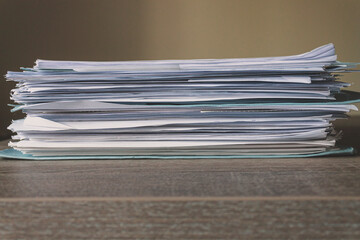 Stack of Documents isolated on a wooden desk. Concept of business, work and education. Copy space