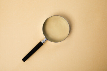 Magnifying glass on orange background